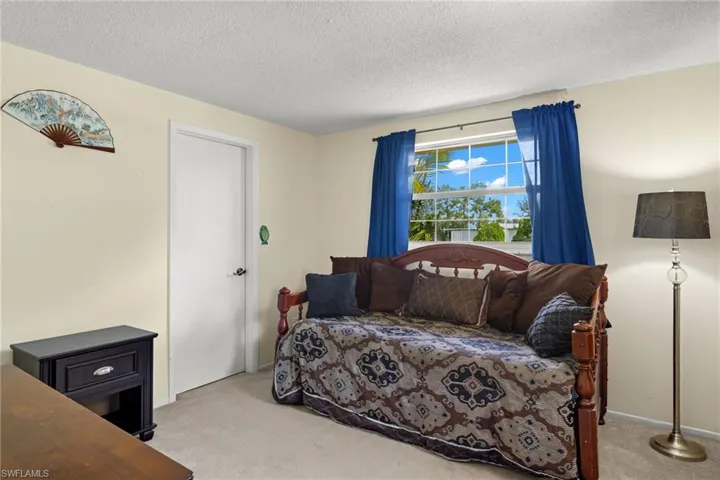 Carpeted bedroom featuring a textured ceiling