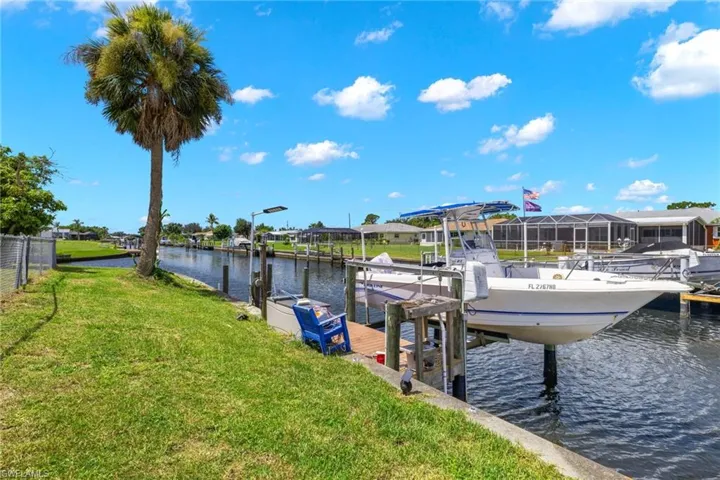 Dock area featuring a lawn and a water view