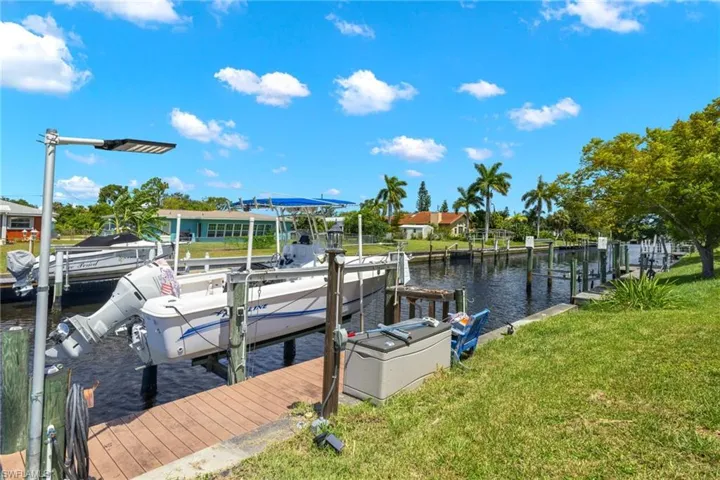 Dock area featuring a water view and a yard