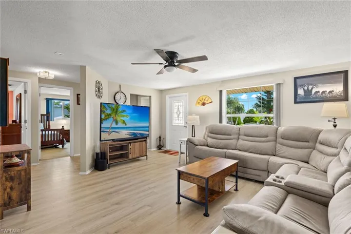 Living room featuring ceiling fan, light wood-type flooring