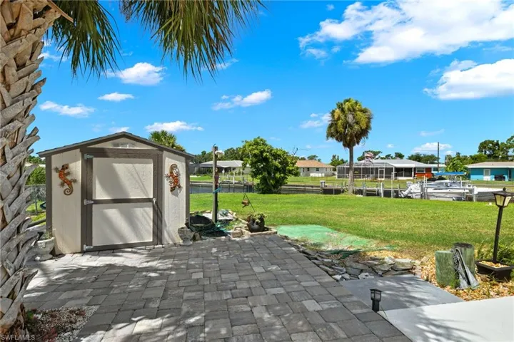 View of patio with a storage shed