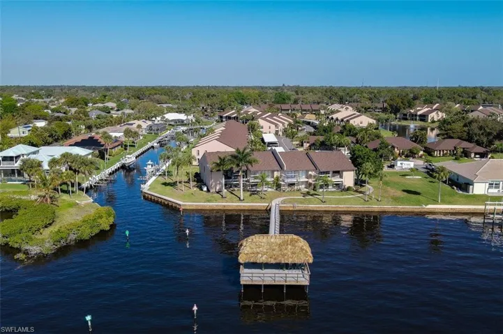 Aerial perspective of suburban area featuring a large body of water