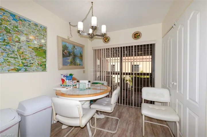Dining space with wood finished floors and a chandelier