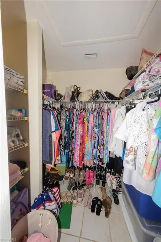 Walk in closet with light tile patterned flooring
