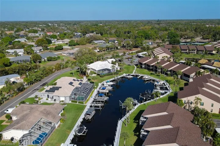 Aerial overview of property's location with a large body of water and nearby suburban area