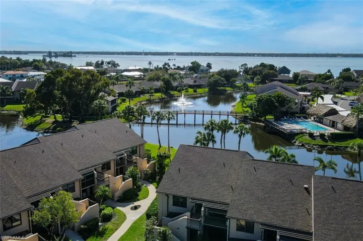 Aerial perspective of suburban area featuring a large body of water