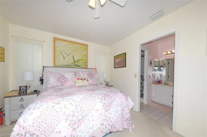 Bedroom with light carpet and ceiling fan
