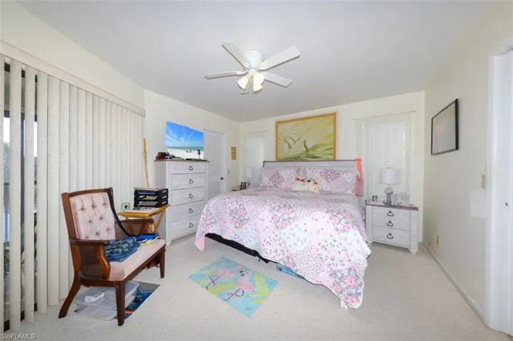 Bedroom featuring ceiling fan and light colored carpet