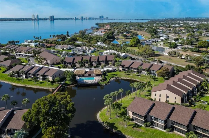 Aerial view of residential area featuring a nearby body of water
