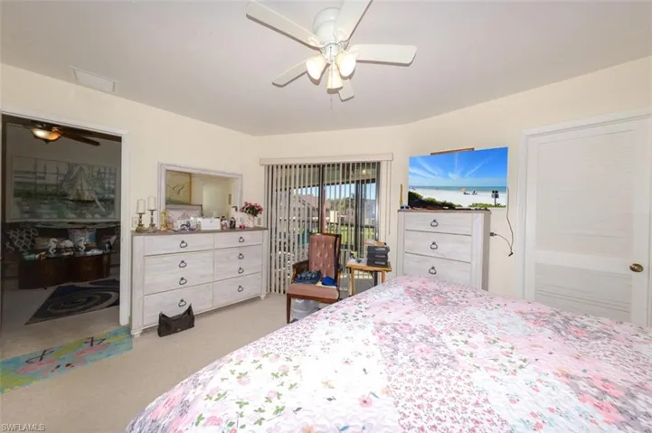 Bedroom with access to outside, ceiling fan, and light colored carpet