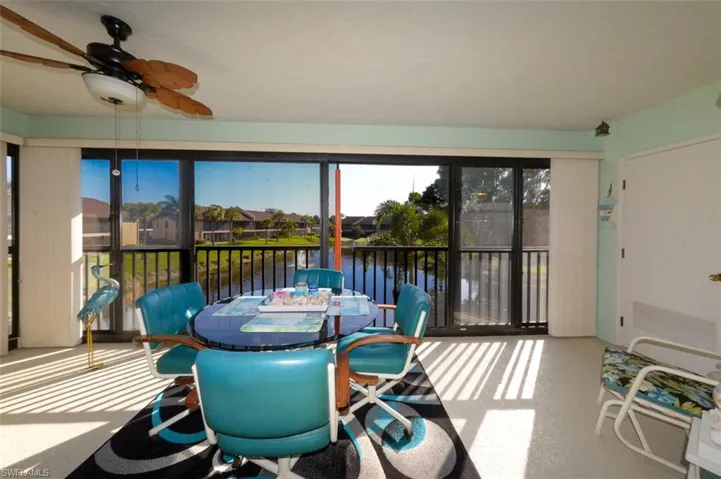 Sunroom / solarium featuring a water view and carpet floors