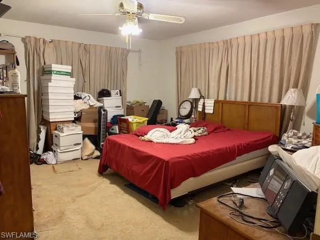 Main bedroom featuring a textured ceiling and a ceiling fan