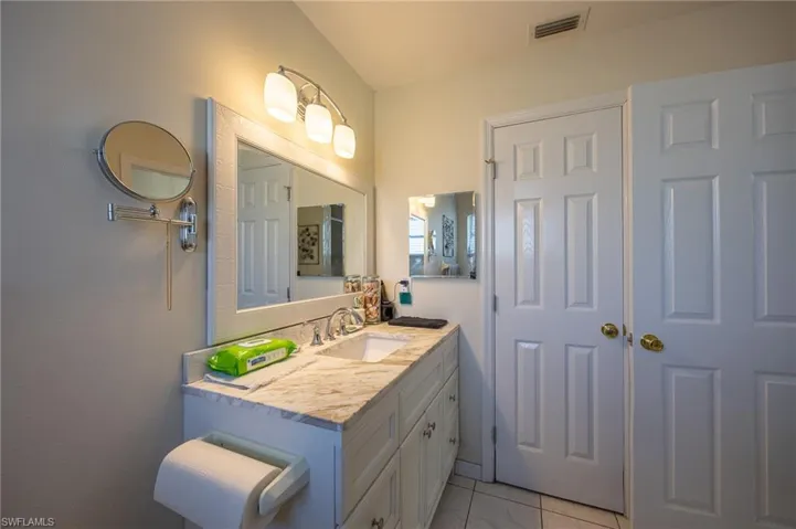 Bathroom with tile patterned floors and vanity