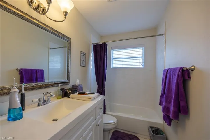 Full bath featuring vanity and shower / bathtub combination with curtain