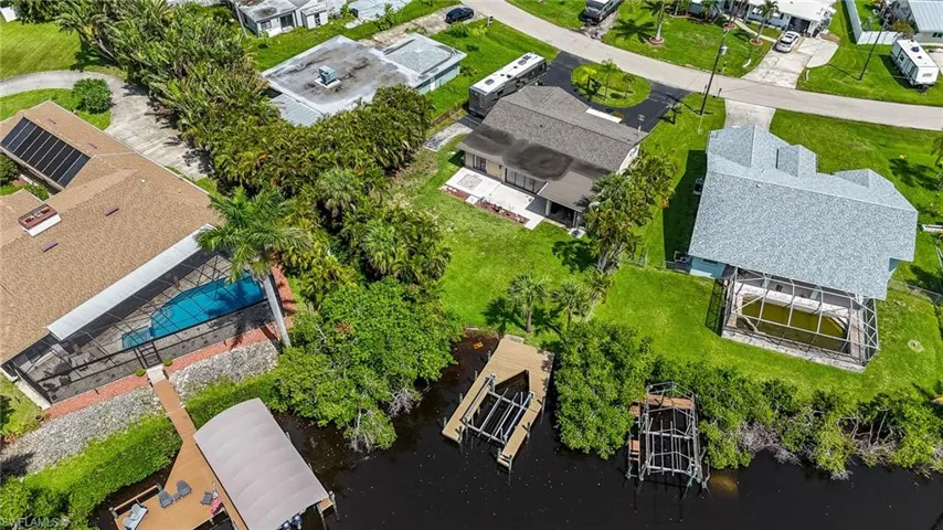 Aerial view of residential area featuring a large body of water