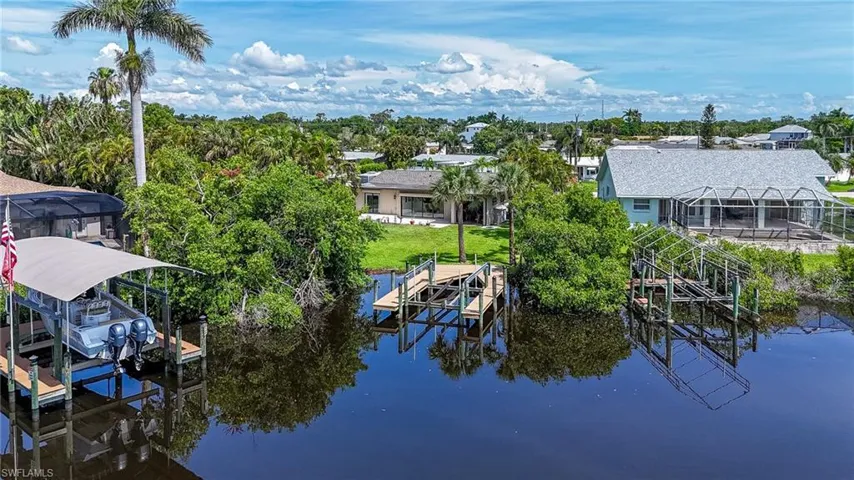 Dock with boat lift and a water view