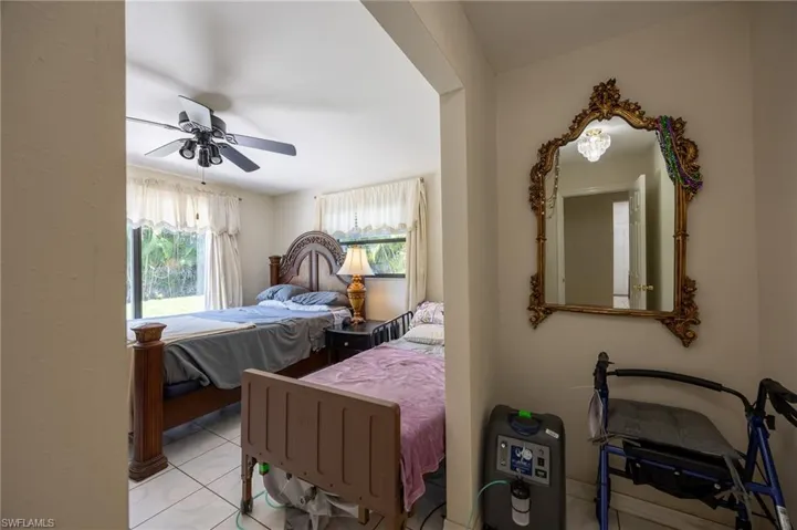 Bedroom featuring a ceiling fan and light tile patterned flooring