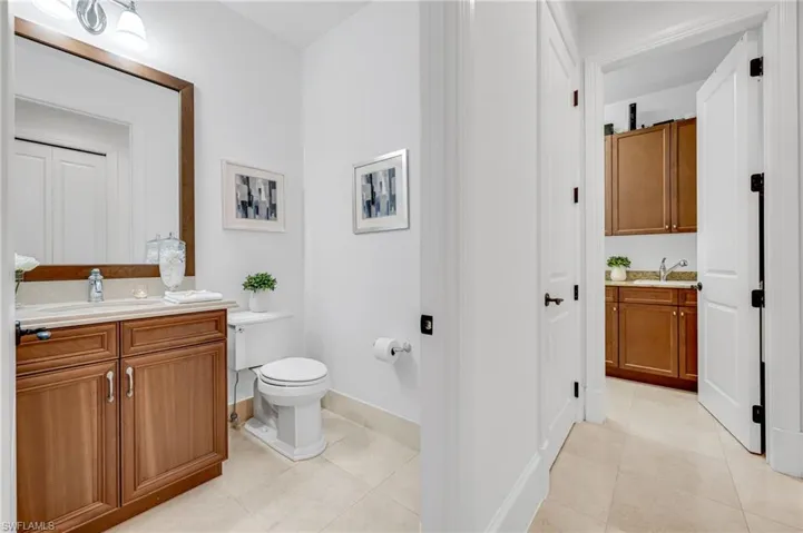 The guest powder room and hallway leading to the laundry room.