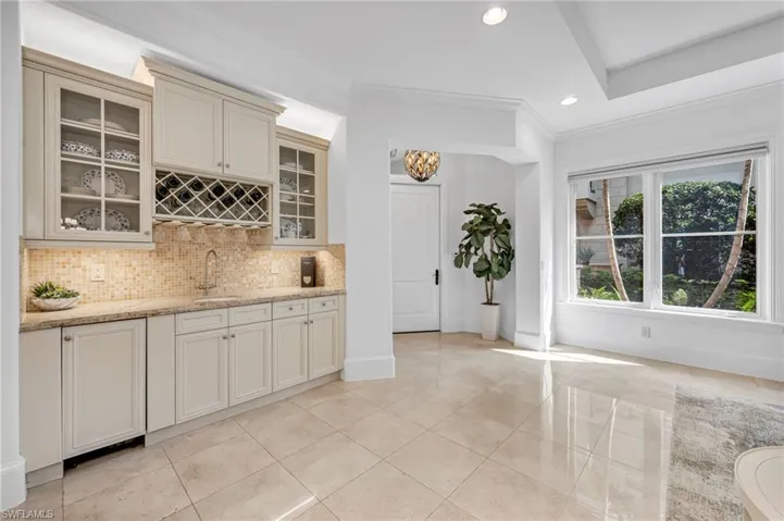 The custom wet bar has an undercabinet Sub-Zero icemaker and abundant storage.