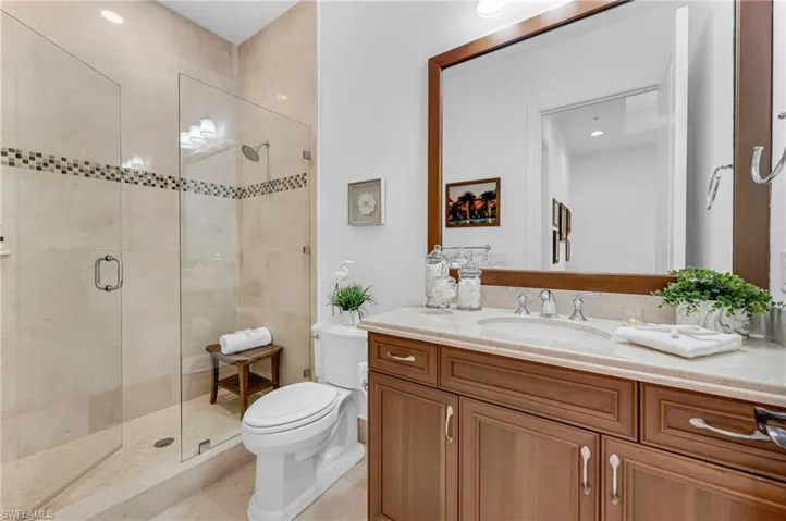 The guest bath has a large, walk-in shower with frames shower doors and plenty of space for guests.