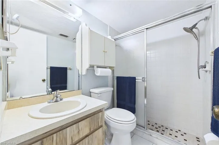 Full bath with vanity and a stall shower