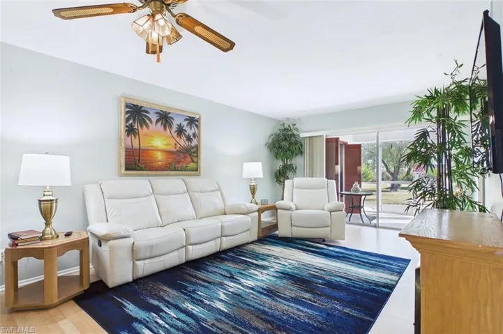Living area with a ceiling fan and wood finished floors