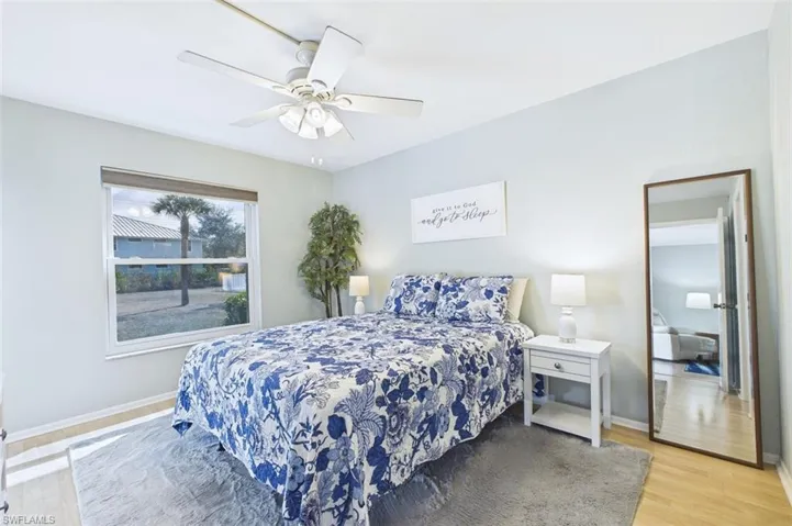 Bedroom with light wood-style floors and a ceiling fan