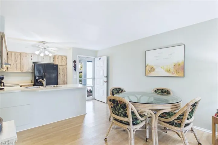 Dining space with light wood-style floors and ceiling fan