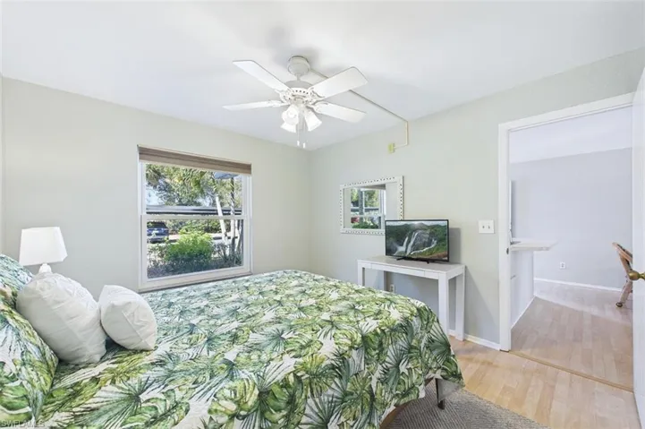 Bedroom with wood finished floors and ceiling fan