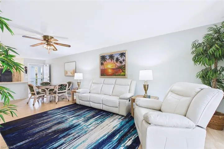 Living room with ceiling fan and wood finished floors