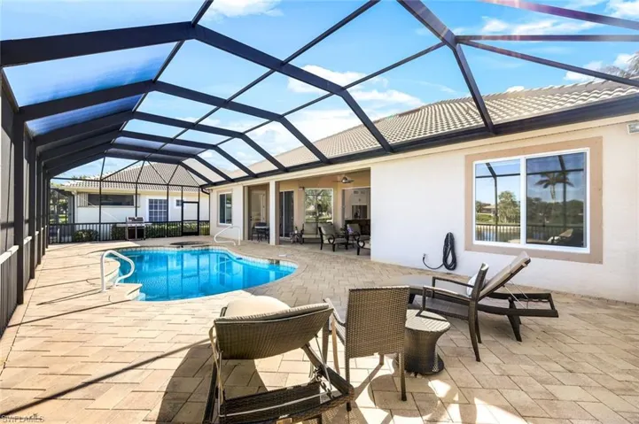 Outdoor pool with glass enclosure and a patio