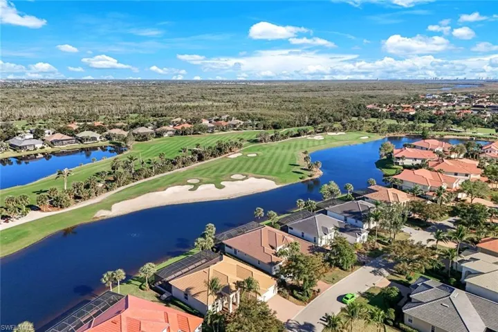 Drone / aerial view featuring a residential view, a water view, and golf course view