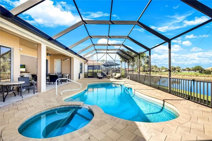 View of swimming pool featuring a water view, and a patio area