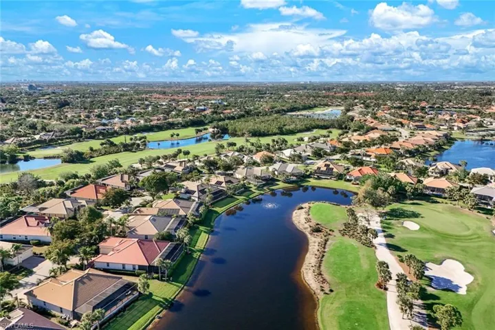 Aerial view featuring a residential view, golf course view, and a water view