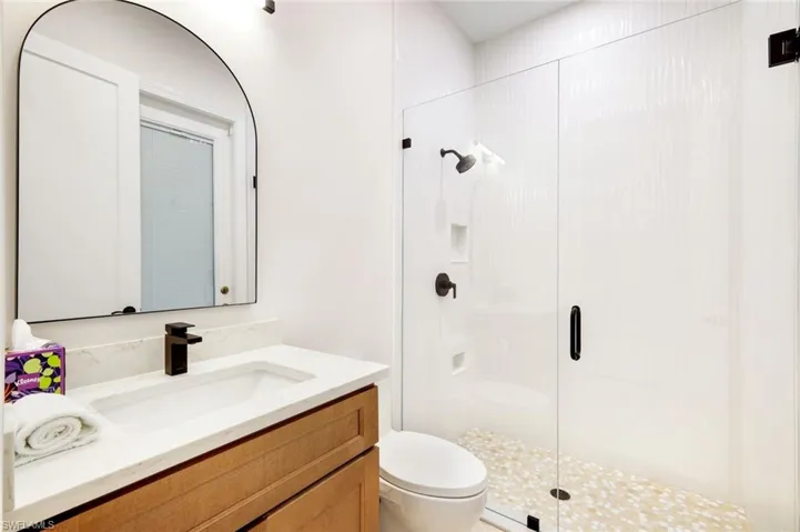 Bathroom, a walk in shower, and vanity