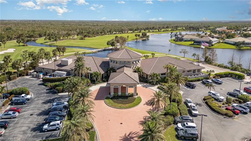 Birds eye view of property with golf course view, a water view, and a residential view
