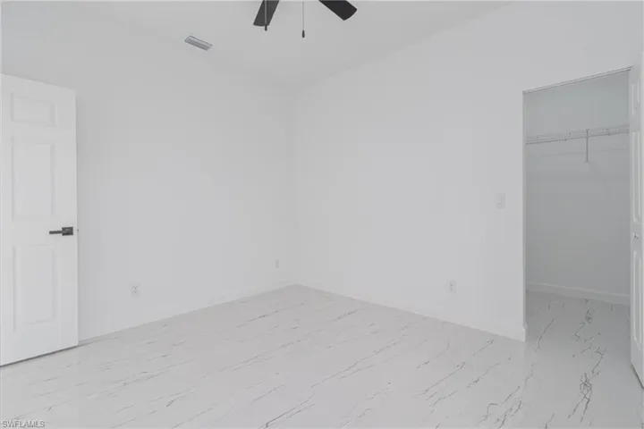 Spare room with ceiling fan