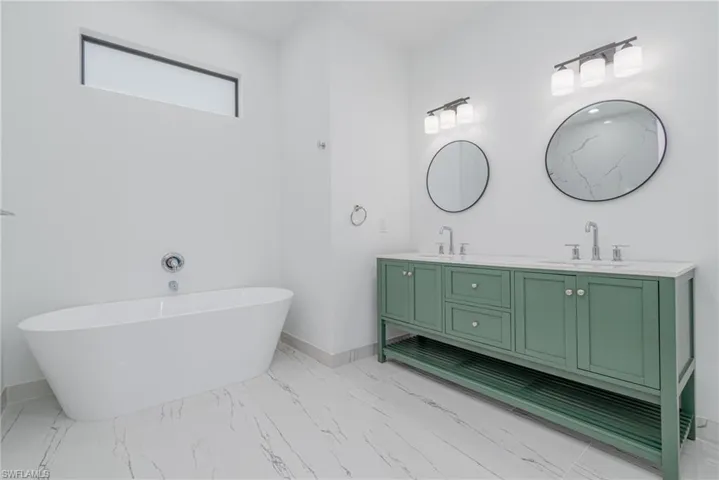 Bathroom with vanity and a bathtub