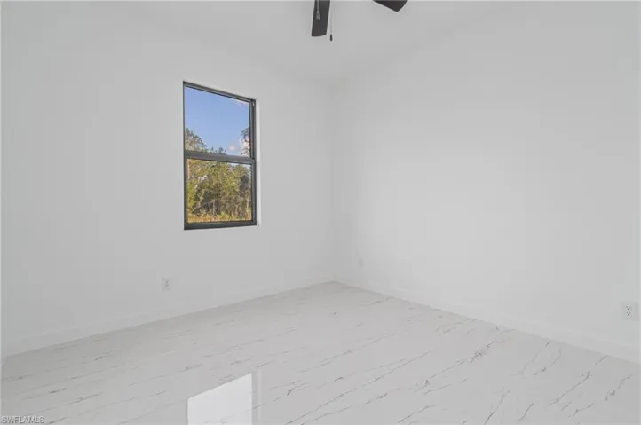 Spare room with ceiling fan