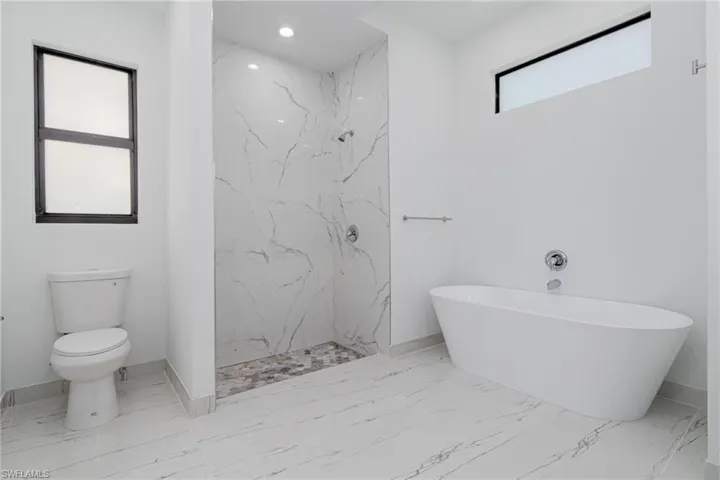 Bathroom featuring independent shower and bath and toilet