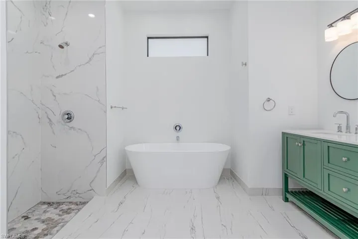 Bathroom with vanity and plus walk in shower