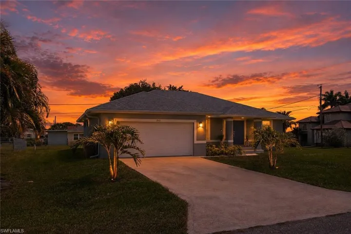 Single-story residence featuring a neutral exterior, attached garage, and concrete driveway