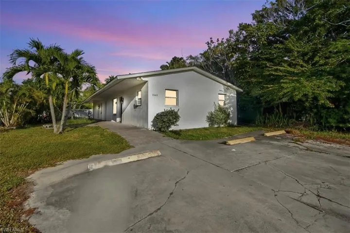 View of front of property featuring a yard and stucco siding
