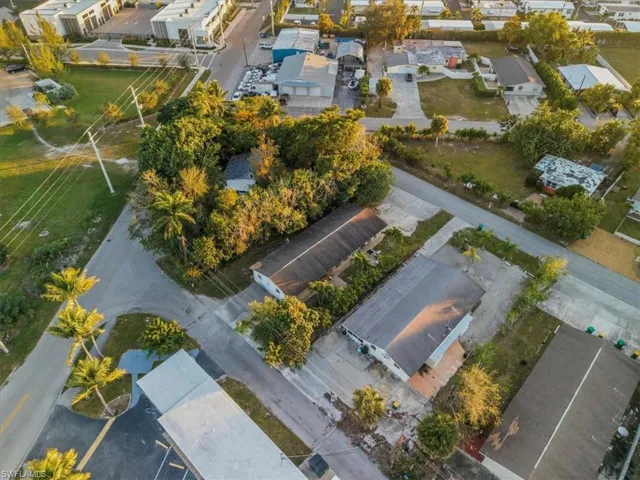 Aerial view of property and surrounding area featuring nearby suburban area