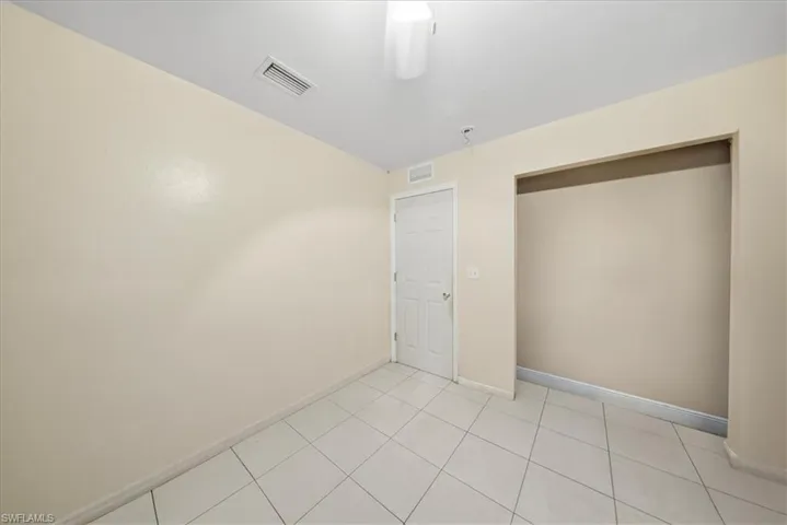 Unfurnished bedroom featuring a closet and light tile patterned flooring