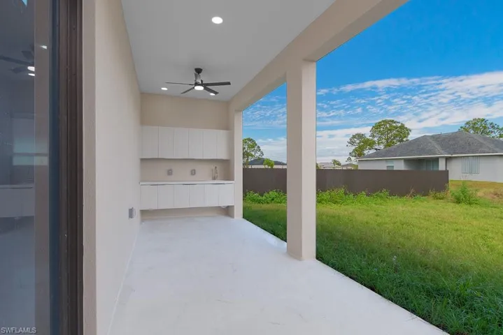 View of patio / terrace featuring fence and a ceiling fan
