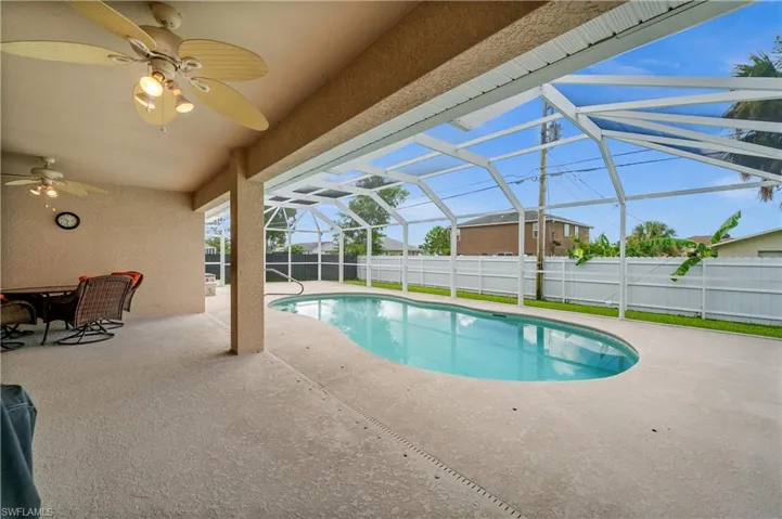 View of pool with a patio area, a sunroom, a lanai, and ceiling fan