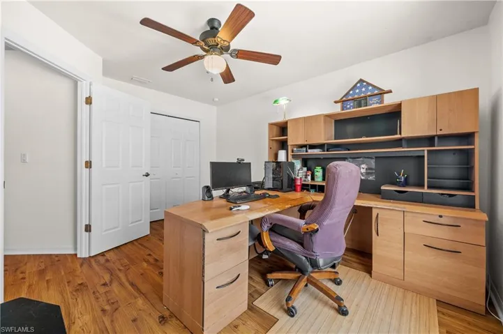 Office space with light wood-style floors and a ceiling fan (4th bedroom)