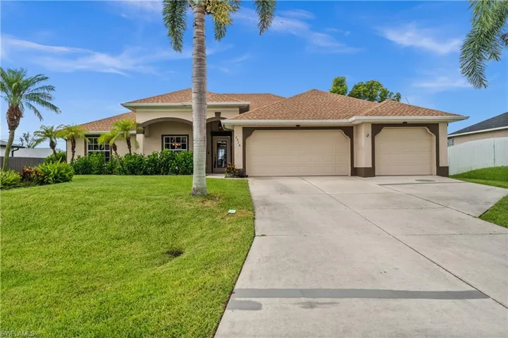 View of front of home featuring an attached garage, stucco siding, driveway, and a shingled roof