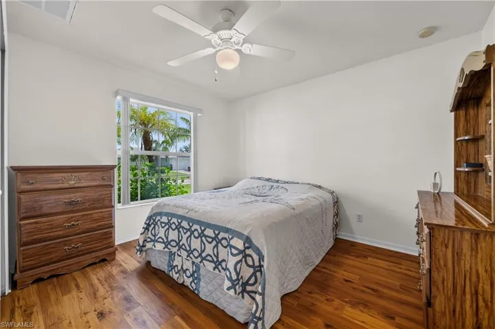 Bedroom with dark wood-style floors and ceiling fan
